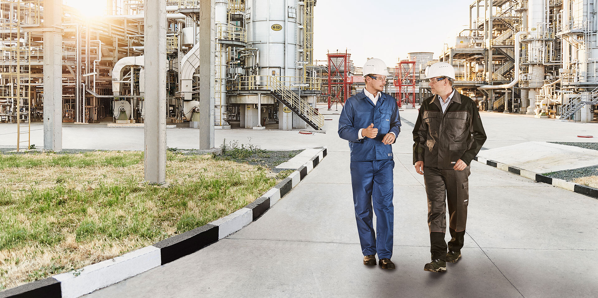 HOERBIGER Reciprocating Compressor Service HOERBIGER Service engineer and customer walking through a refinery.