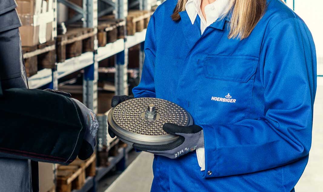 Reliable supply of spare parts A warehouse with spare parts and a valve in focus